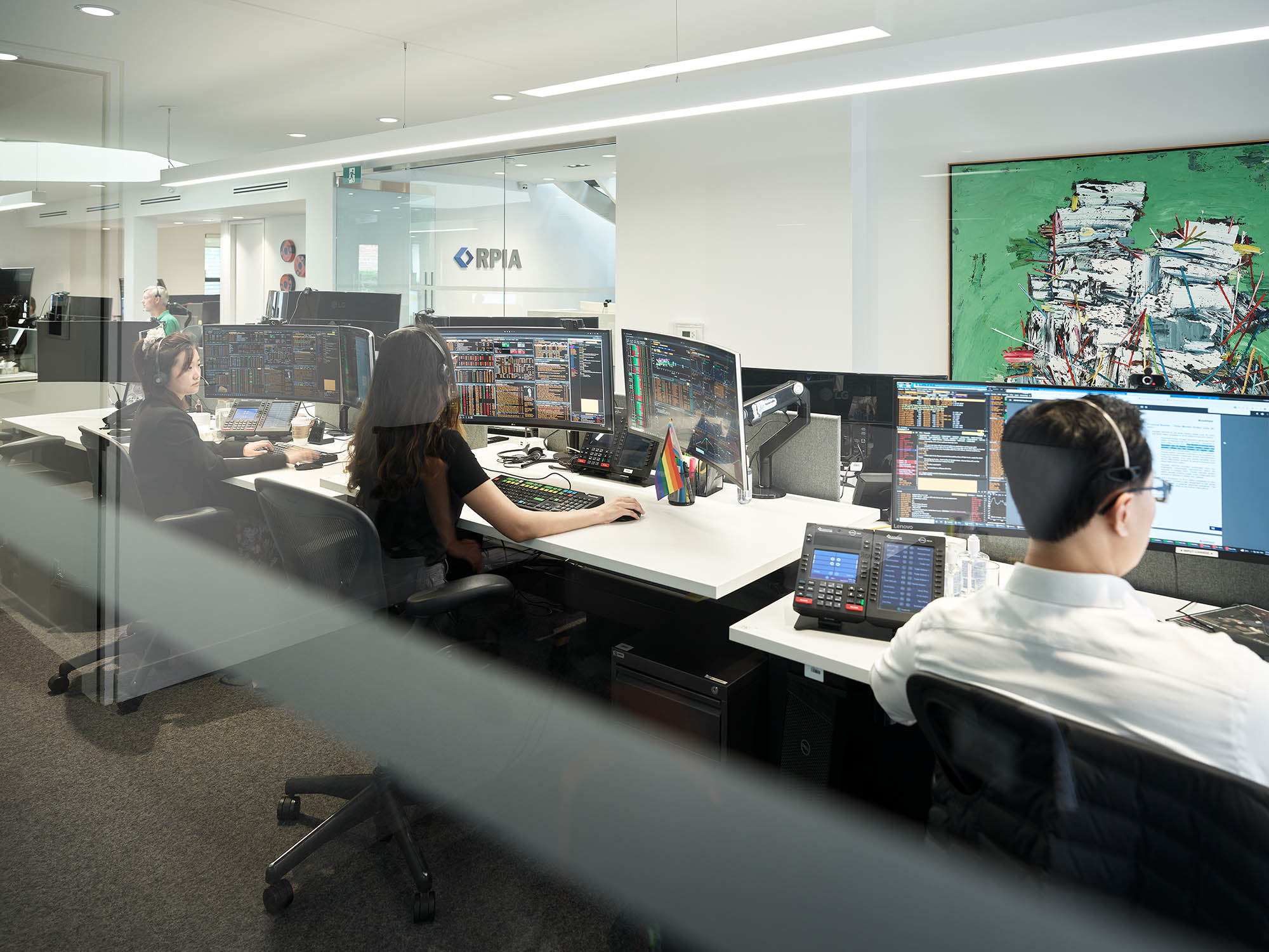 Three people using their computers
